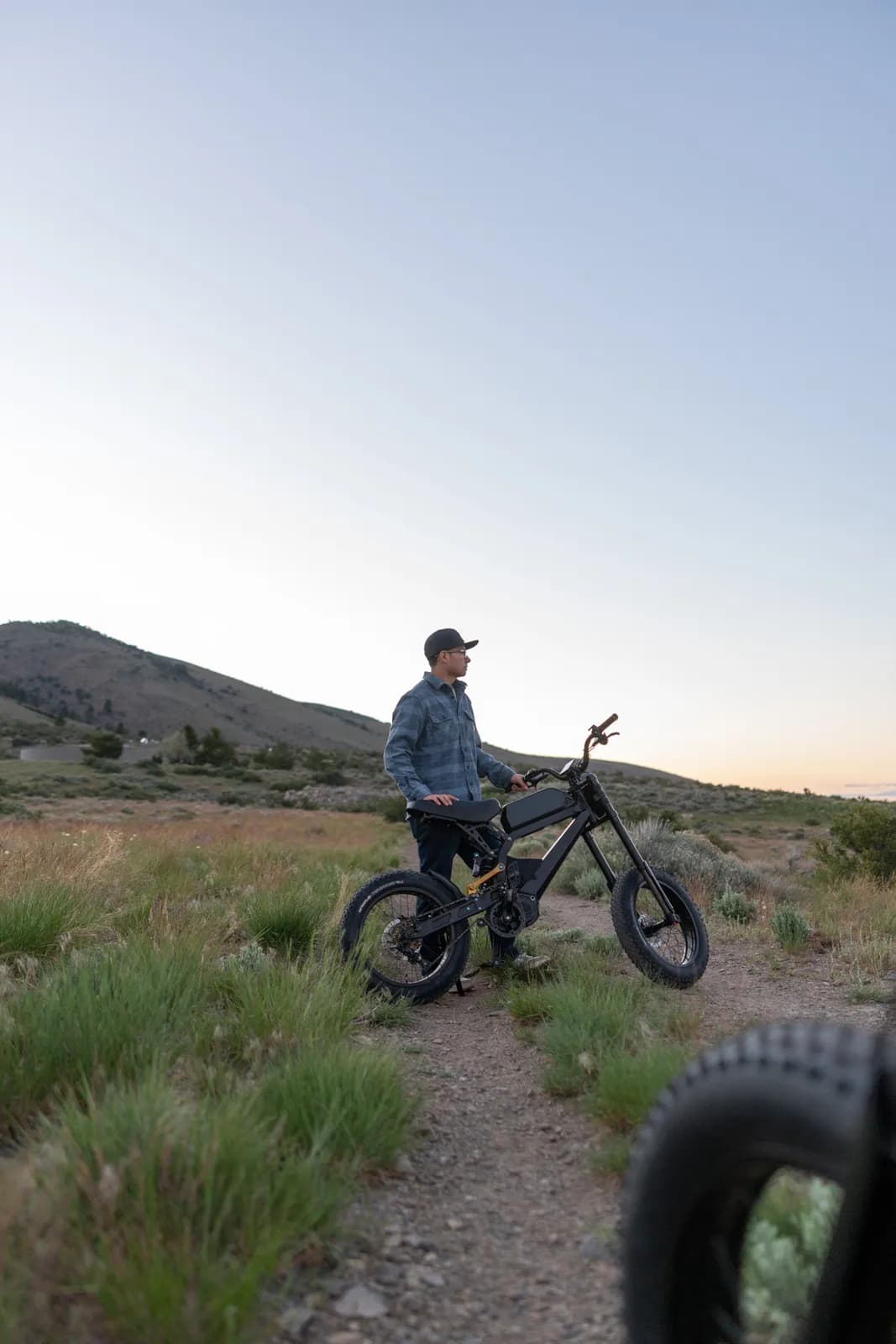 Rider with the Surfline e-bike on a high-desert trail at dusk